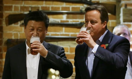 British Prime Minister David Cameron (R) drinks a pint of beer with Chinese President Xi Jinping at a pub in Princess Risborough near Chequers, northwest of London, on October 22, 2015. The two leaders met for talks and dinner this evening during a state visit hailed as a landmark by both China and Britain. AFP PHOTO / POOL / Kirsty WigglesworthKIRSTY WIGGLESWORTH/AFP/Getty Images