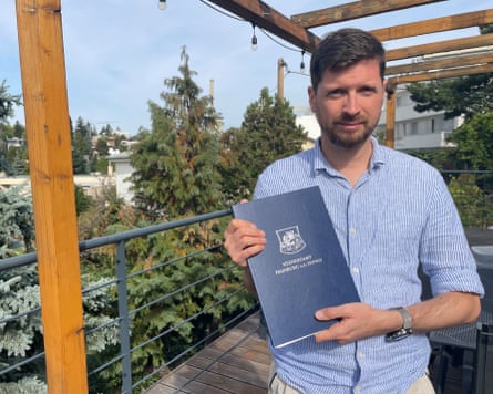 Marián Žáry Kukelka holds his marriage certificate