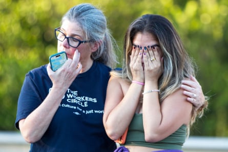 two women cry next to each other
