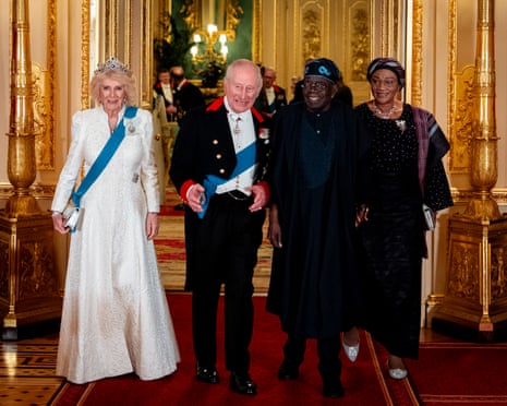 Queen Camilla, King Charles, Bola Tinubu and Oluremi Tinubu stand in a grand, ornate hallway
