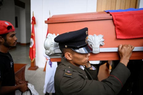 Military personnel carry a casket during the funeral for soldiers at a cemetery in the Venezuelan capital, Caracas.