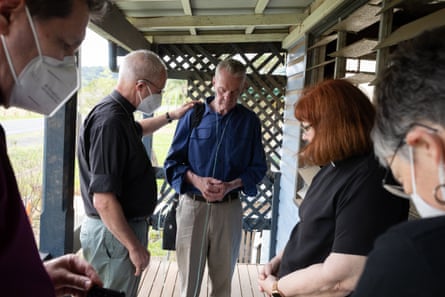 The archbishop of Canterbury Justin Welby prays with Ray Nichols at his home that was damaged in the floods