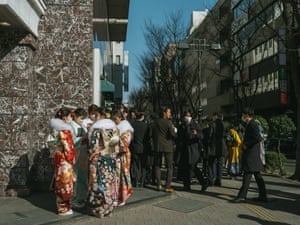 Young women and men stand on the street after a Coming of Age Day ceremony at Yokohama Arena