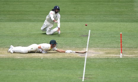 David Warner slips but survives a run-out attempt by the skin of this teeth after Haseeb Hameed misses the stumps at the Gabba.
