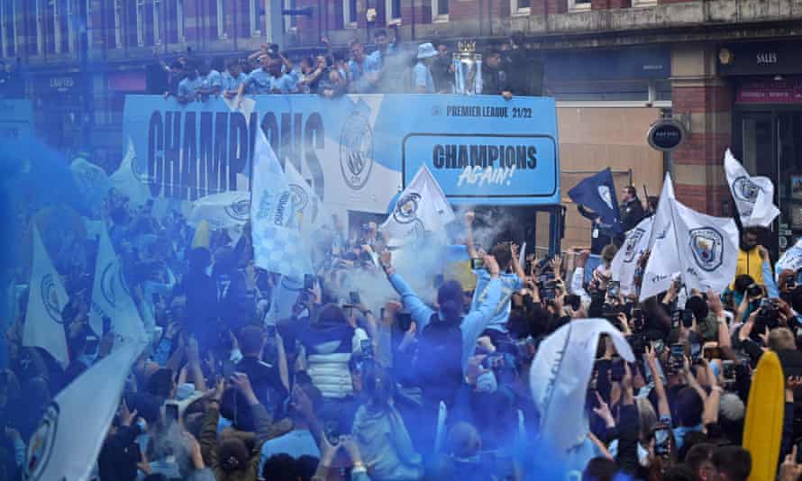 Manchester City’s players enjoy their open-top bus parade through the city centre.