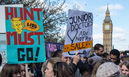 Doctors hold up protest signs while striking outside St Thomas’ hospital in April 2016.