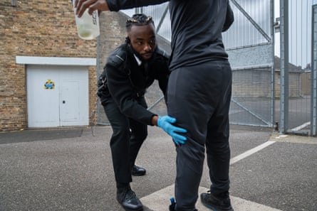 Chibs Ekeiwu searches a prisoner
