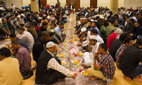 Muslims prepare to eat iftar, the evening meal to break fast during Ramadan, at the East London mosque, in Whitechapel, London.