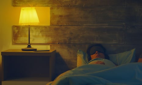 Woman in bed with lamp on