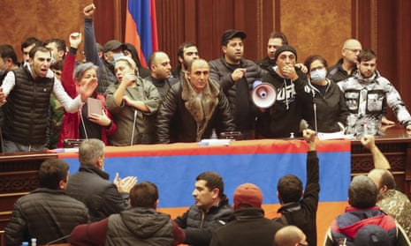 People shout as they broke into the parliamentary building protesting against an agreement to halt fighting over the Nagorno-Karabakh region, in Yerevan, Armenia, Tuesday, Nov. 10, 2020. Armenian Prime Minister Nikol Pashinian said on Facebook that calling an end to the fight was "extremely painful for me personally and for our people." Soon after the announcement, thousands of people streamed to the main square in the Armenian capital Yerevan to protest the agreement, many shouting "We won't give up our land." Some of them broke into the main government building, saying they were searching for Pashinian, who apparently had already departed. (AP Photo/Dmitri Lovetsky)