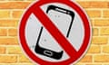 A no smartphone sign on a brick wall.