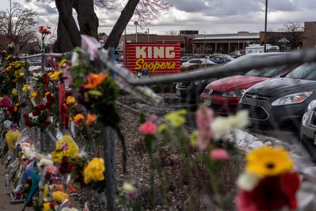 Memorials and flowers are left on the fencing surrounding the King Soopers grocery store where an attacker opened fire.