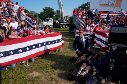 People react after shots were fired at Donald Trump during a campaign rally, on Saturday, in Butler, Pennsylvania.