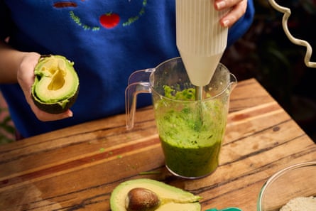 Chef adding avocado to the pea guacamole