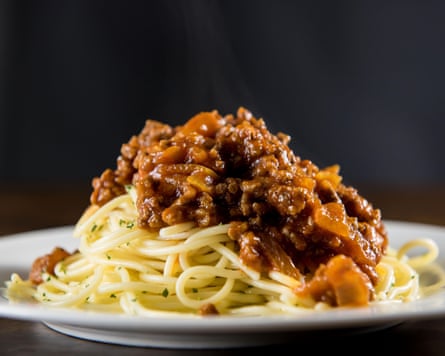 Spaghetti bolognese on a white plate on the table