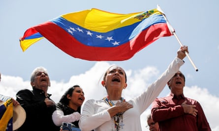 Opposition leader Maria Corina Machado waves a Venezuelan national flag during a rally to protest official results
