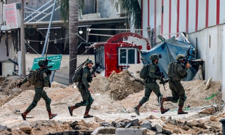 Israeli soldiers take position during an army operation in Tulkarm, 29 August 2024.