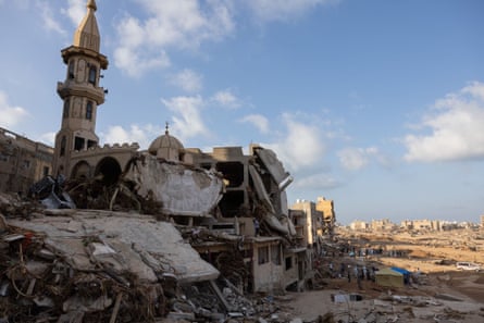 The collapsed floor and roof of a mosque with a wasteland seen in the background