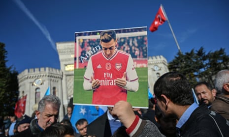 A supporter of China’s Muslim Uighur minority holds a placard Mesut Ozil during a demonstration at Beyazid square in Istanbul.