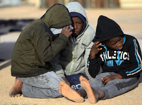 Children wait at a naval base in the Libyan capital, Tripoli, after being rescued off the coast of Garabulli