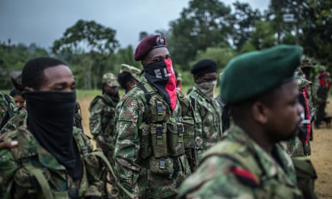 National Liberation Army (ELN) guerrillas stand in formation during a meeting in a remote village in Chocó, Colombia.