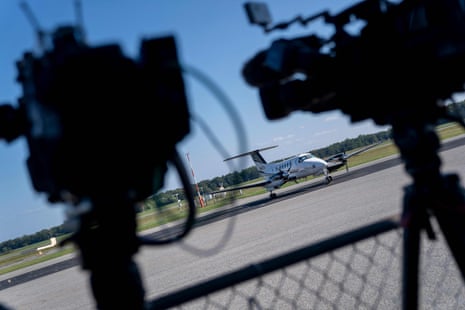 A plane on tarmac with cameras pointed towards it.