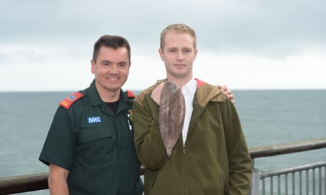 Sole survivor Sam Quilliam (right) at Boscombe pier in Dorset where he was saved by paramedic Matt Harrison (left) after accidentally swallowing the 14cm fish. 