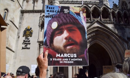 A demonstrator holds up a photo of Marcus Decker during a demonstration in July.
