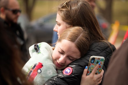 Two women hug after the school shooting at East high school on 22 March.