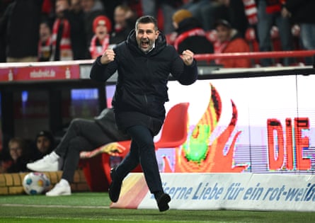 Nenad Bjelica takes off down the touchline to celebrate Union Berlin’s second goal with his players.