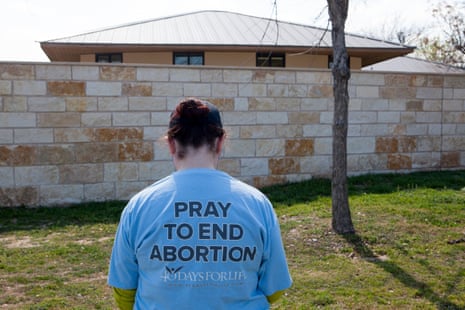 An anti-abortion activist prays outside a Planned Parenthood clinic in Austin that offers abortions.