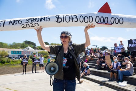A civil rights protester showcasing the amount of money G7 countries spent on arms in 2020