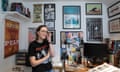 Anna Readman in a studio  filled with framed prints and memorabilia