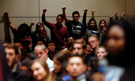 Undocumented Texas A&amp;M students and their supporters protest silently as Spencer speaks.