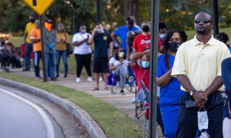 Voters stand in line for up to eight hours in front of southern Cobb regional library for the first day of early voting in Cobb County, Georgia