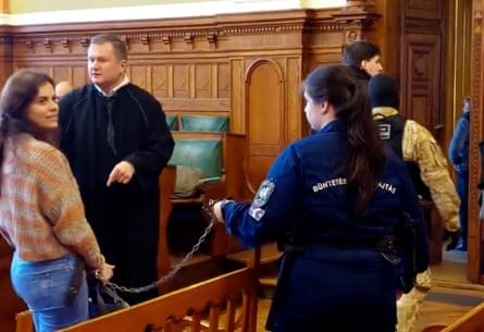 Ilaria Salis in court being held by a chain
