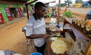 Young man preparing rolex - Uganda’s favourite street food.
