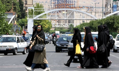 Iranian women cross a road in the capital Tehran on June 15.