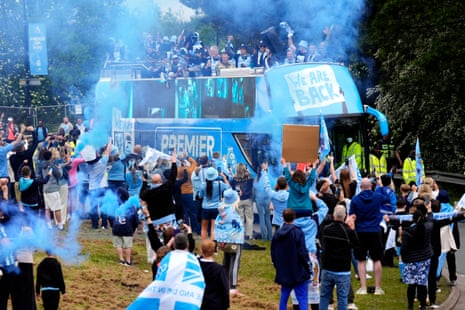Fans cheer as Coventry’s open-top bus goes past during Monday’s victory parade