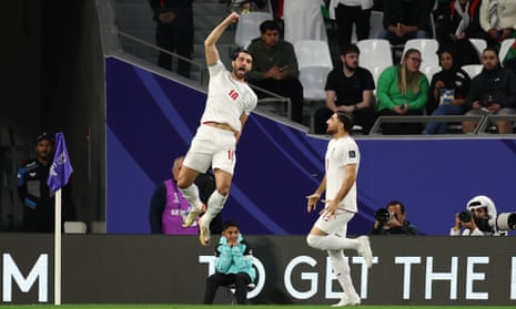 Karim Ansarifard (left) celebrates his goal against Palestine