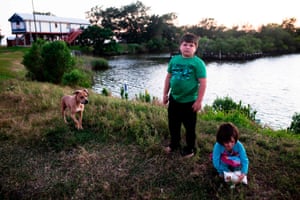 Children on Isle De Jean Charles, Louisiana, where only 20 families are left. Channels cut by loggers and oil companies eroded the island. What little remains will eventually be inundated as the sea level rises.