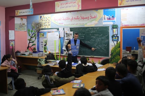 Ismail Wahba, director of the UNRWA Taif school in Rafah, teaches an english class in the library of the school housing displaced Palestinians, in Rafah on 4 March 2024.