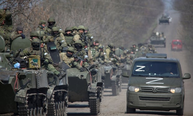 Pro-Russian troops ride on armoured vehicles on a road leading to Mariupol, southern Ukraine, on Friday. 
