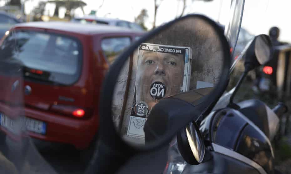 An anti-referendum poster showing Matteo Renzi is reflected in a scooter mirror in Rome.
