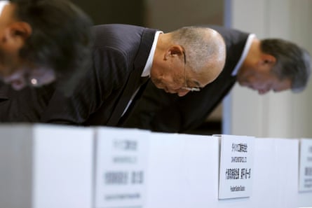 Daihatsu Motor’s president Soichiro Okudaira and other executives, bow during a press conference in Tokyo.