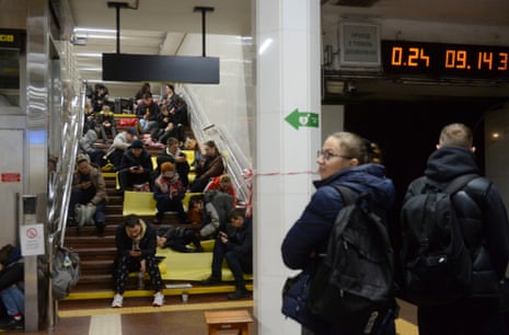 People shelter inside a metro station after a shelling in Kyiv.