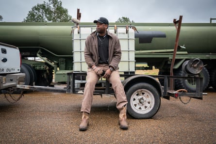 Cedric Weeks poses for a portrait after filling his 900 gallon container at a water distribution site in Jackson, Mississippi on March 2, 2021.