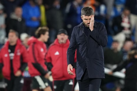Michael Carrick wipes his face while walking off the pitch.