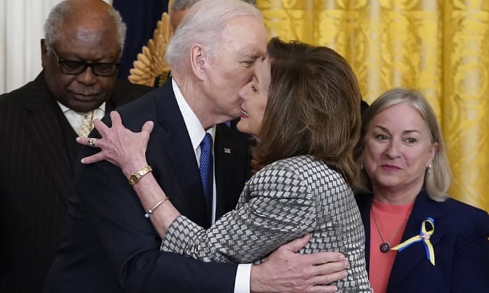 President Joe Biden kisses House Speaker Nancy Pelosi during an Affordable Care Act event in the East Room of the White House in Washington, Tuesday, April 5, 2022. At left is House Majority Whip James Clyburn, D-S.C., and right is Rep. Susan Wild, D-Pa.