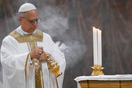 Pope Leo shaking a censer (a metal vessel with chains) to disperse the smoke from burning incense